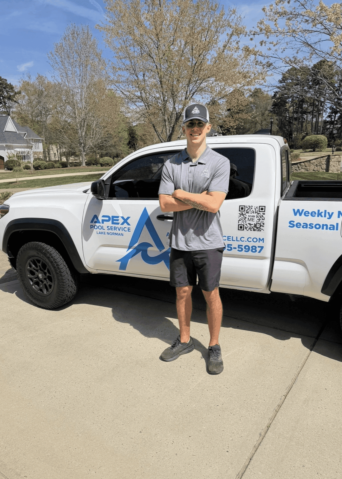Jordan 'JJ' Woodin standing in front of the Apex Pool Service truck